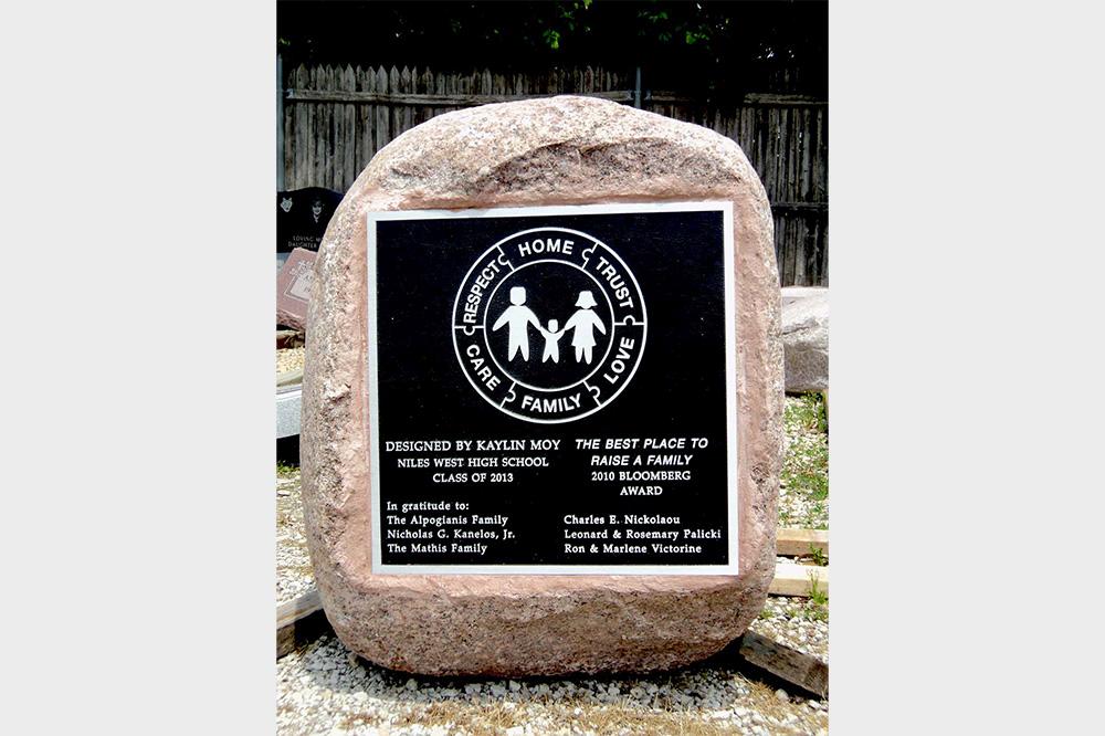 Tall boulder with engraved black metal plaque