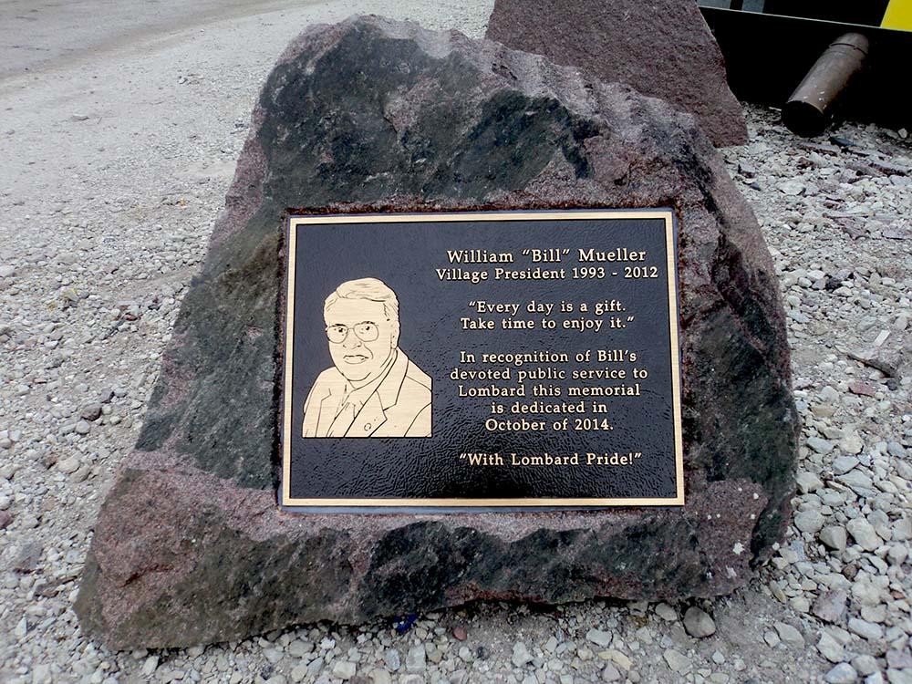 Bronze plaque with etched portrait on a boulder