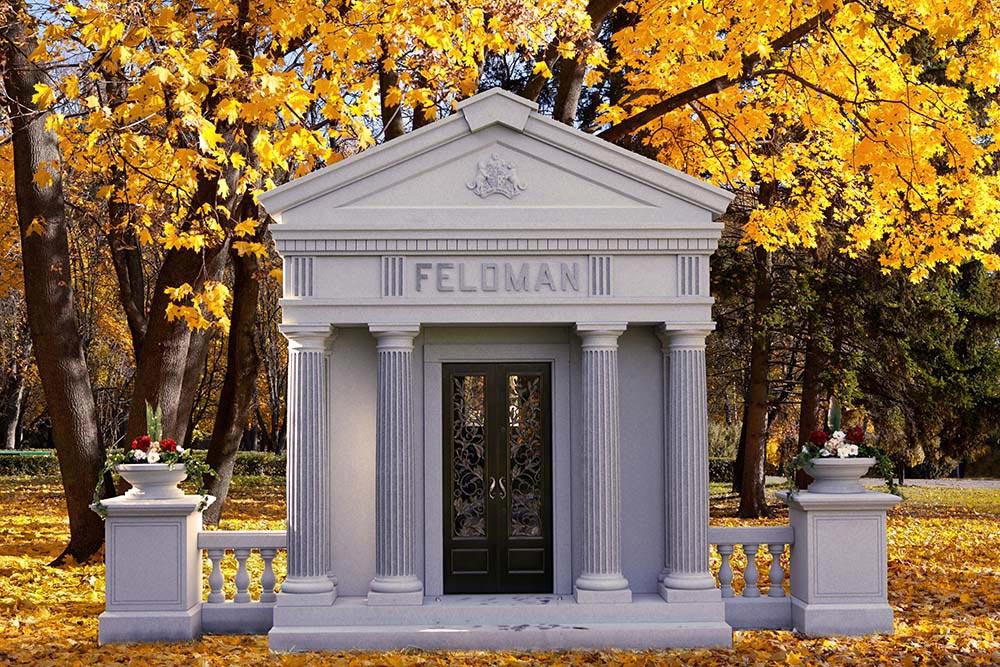 Private mausoleum with fluted columns, custom bronze doors in fall scenery