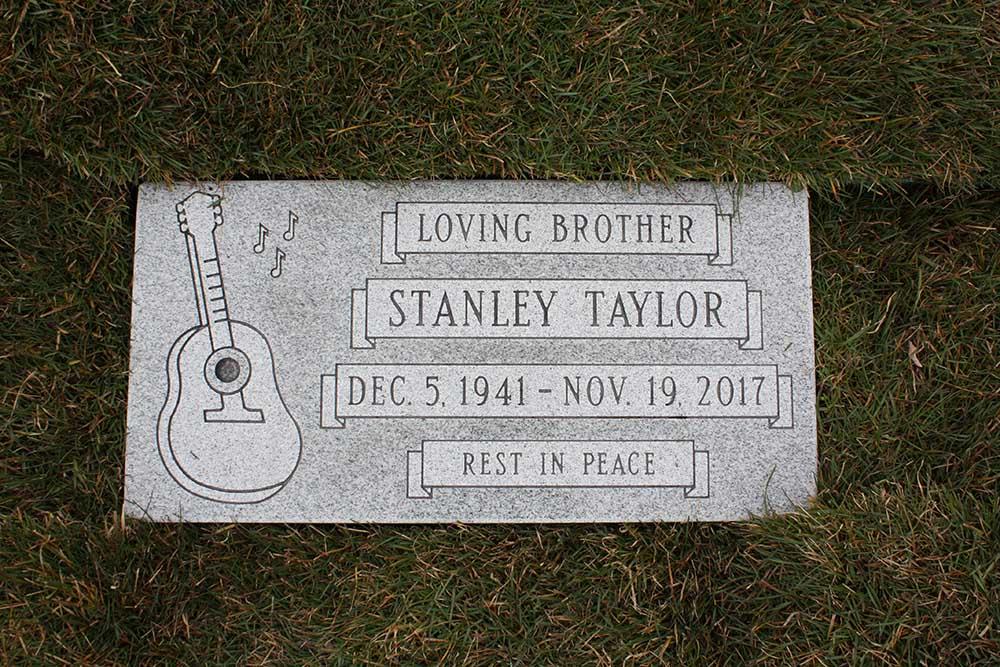 Grey granite marker with guitar