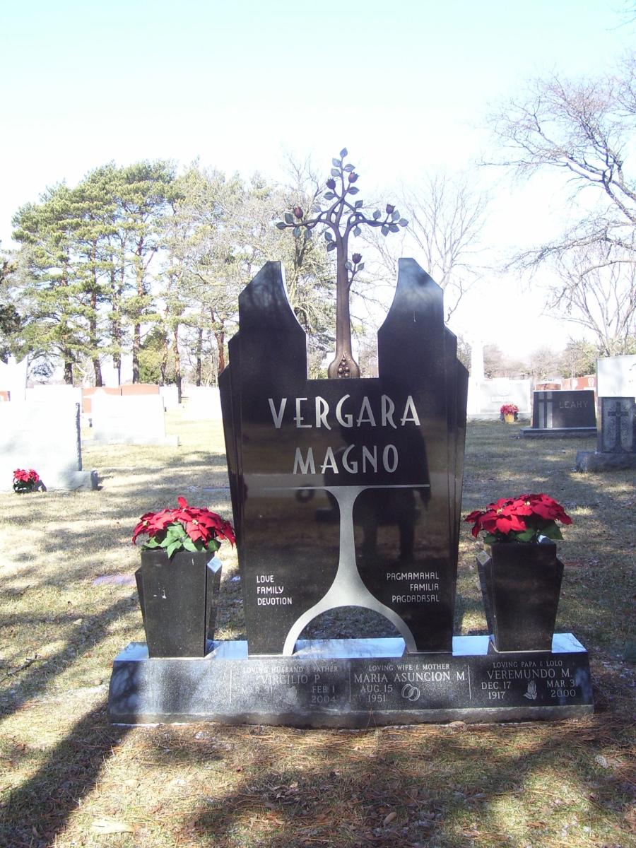 Family monument made with black granite with contemporary bronze cross, 2 last names, vases