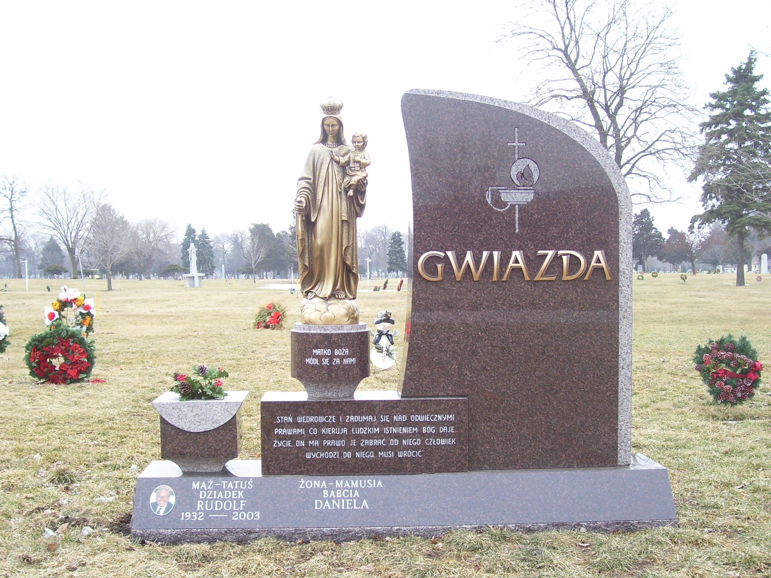 Family monument made with brown granite and statue of Mary with child, bronze letters, ceramic photo, Polish verse