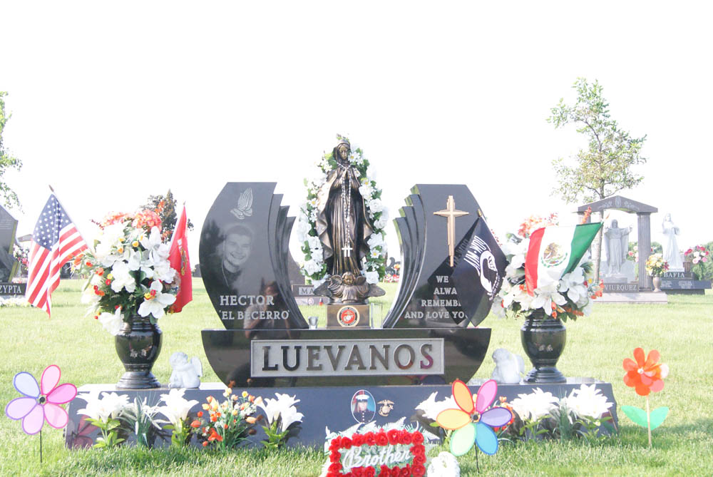 Family monument in black granite with Our Lady of Guadalupe statue