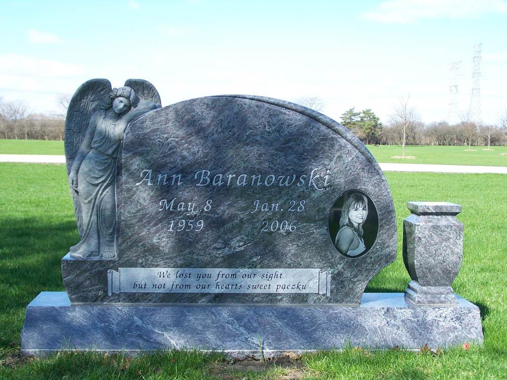 Family monument in blue granite with an angel sculpture