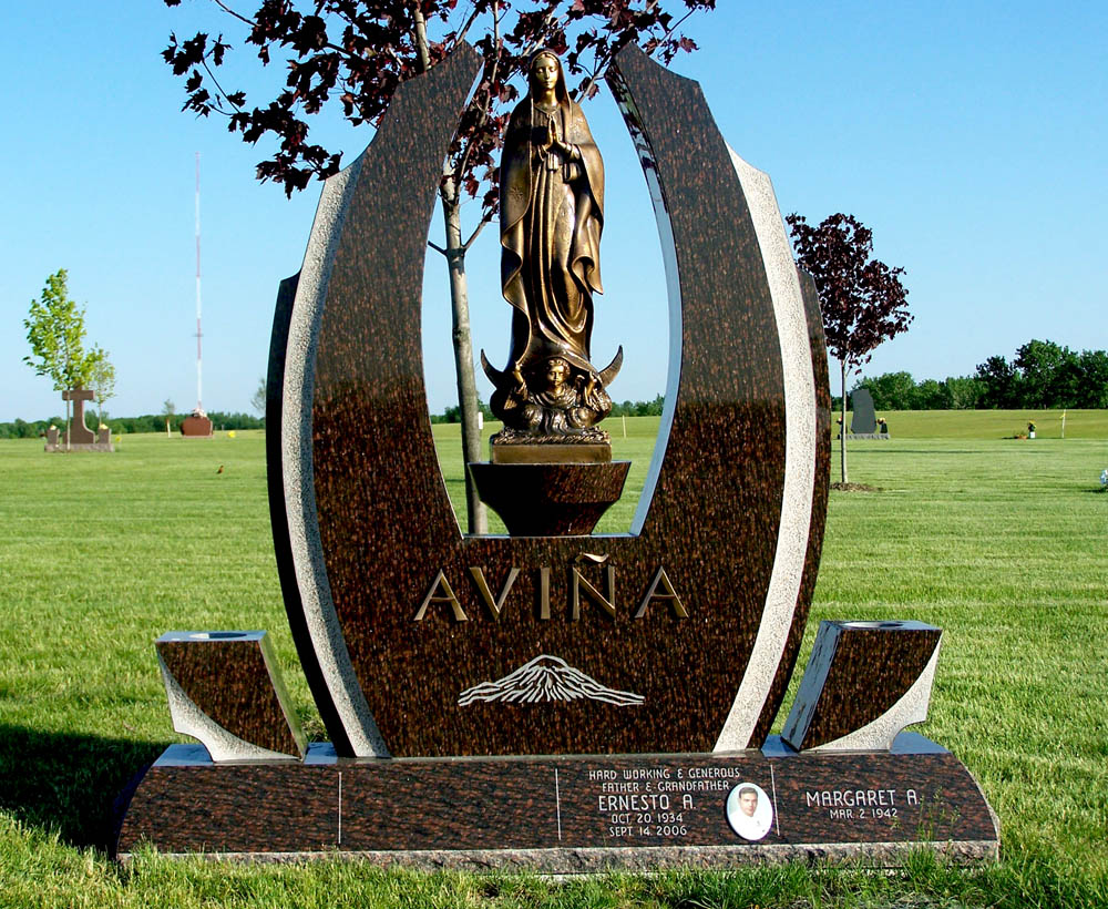 Family monument in brown granite with Christian statue and bronze letters