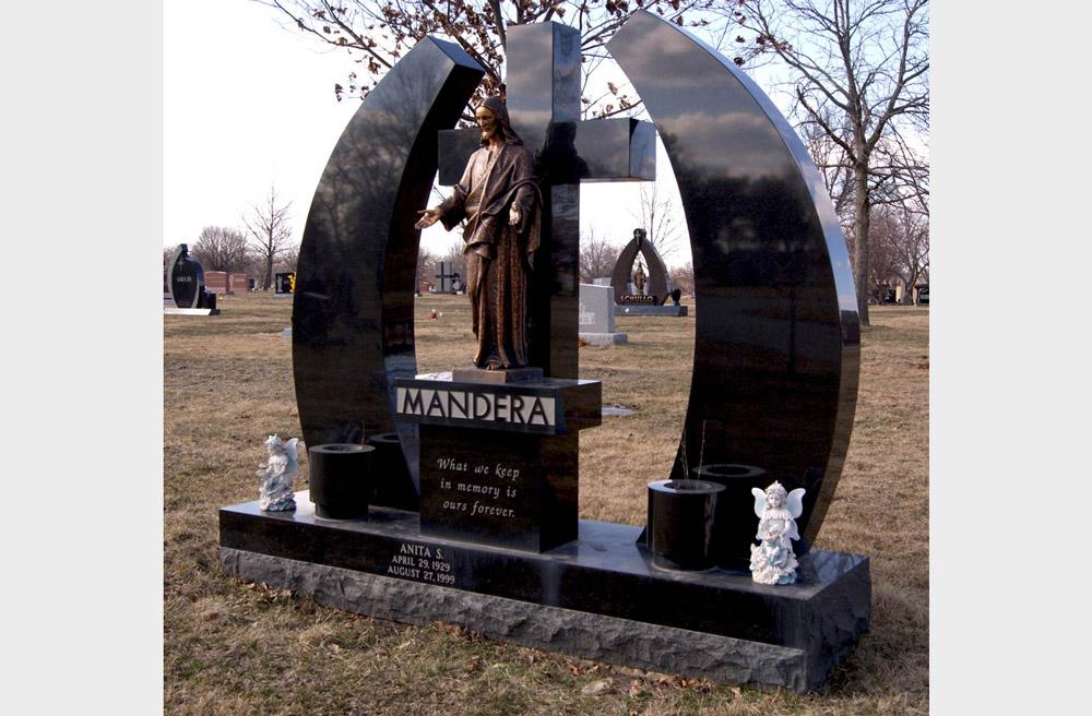 Large family monument in black granite with bronze statue of Jesus