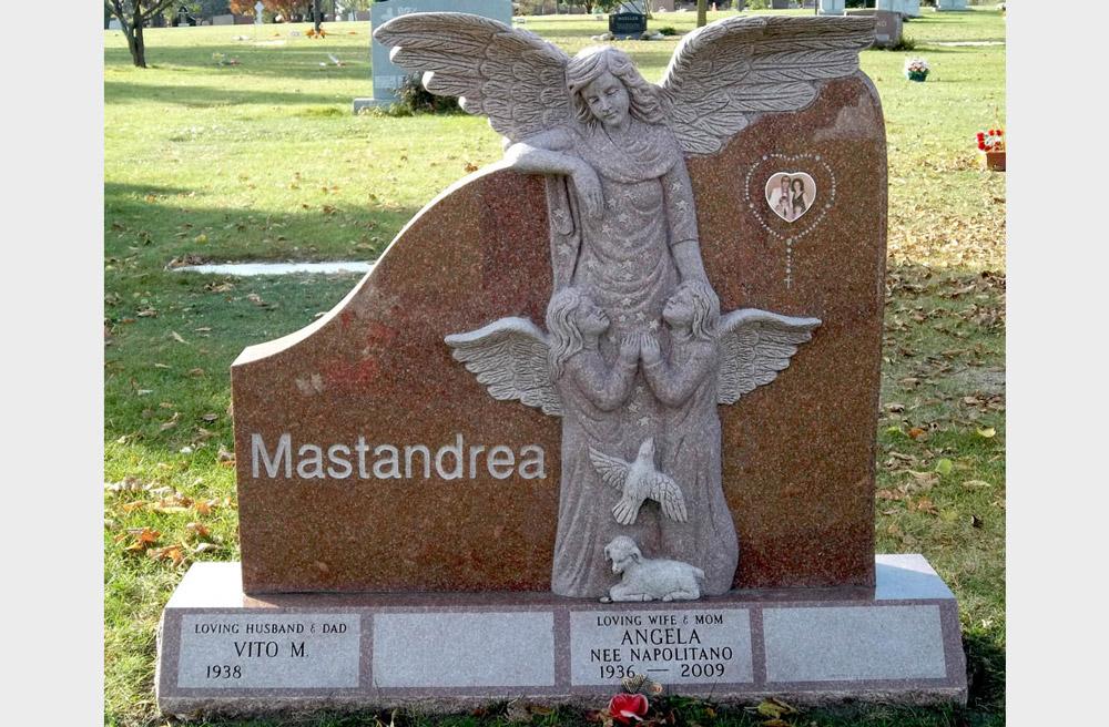 Family monument in red granite with angel sculpture and ceramic photo