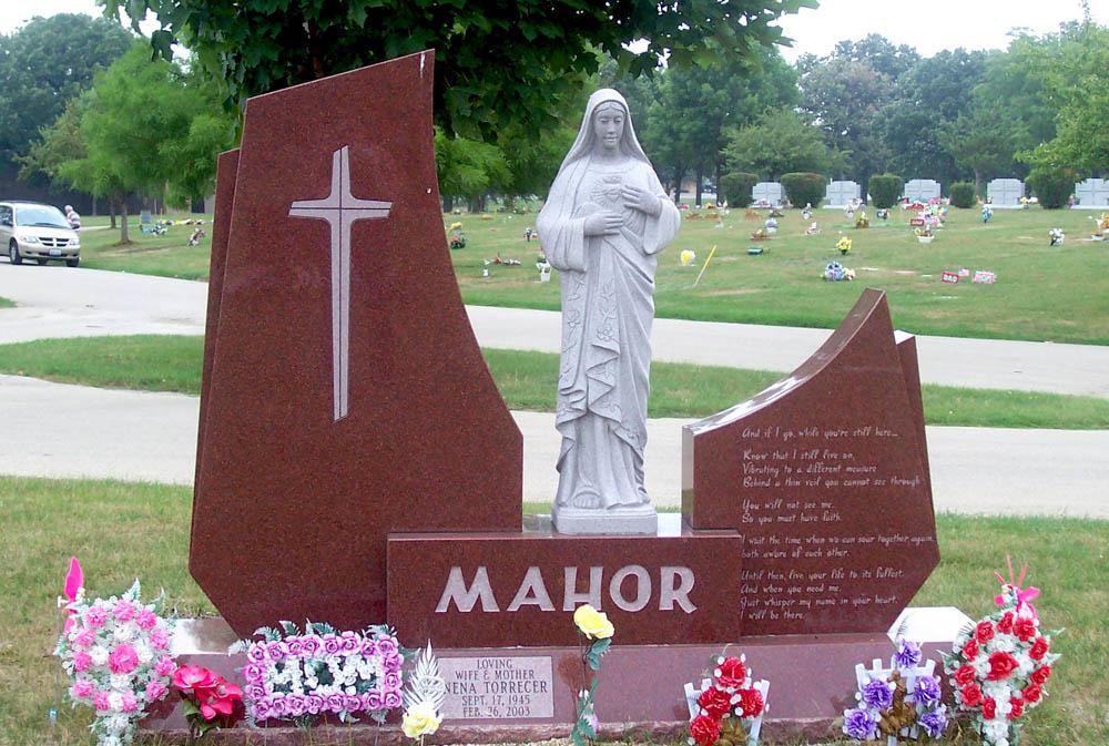Red granite family monument with statue of Mary