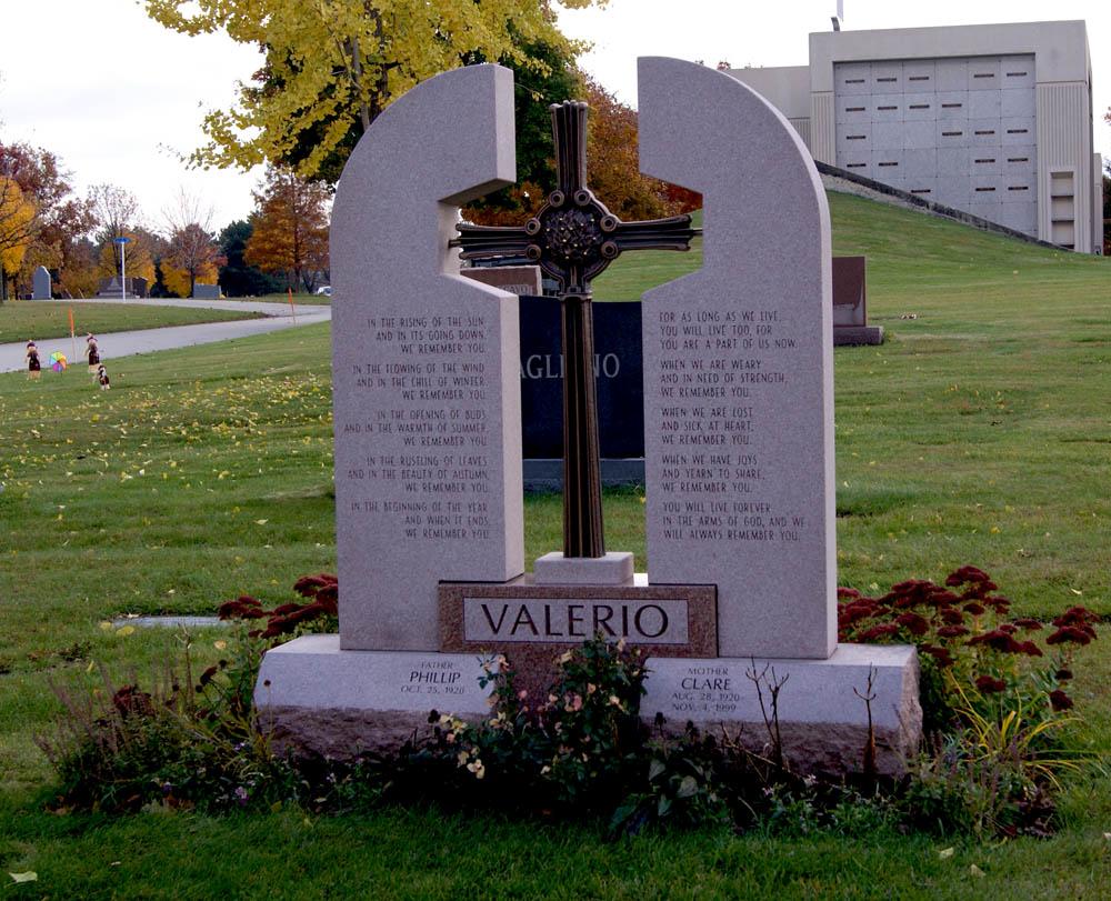 Family monument in rose colored granite with a bronze cross